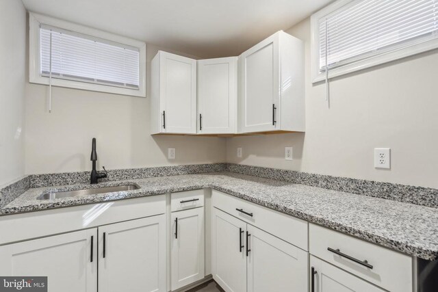 2215 Hoover Rd W, Haywood, VA 22722 - kitchen featuring a sink, white cabinets, and light stone counters