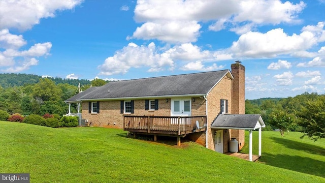 1117 Poor House Rd, Banco, VA 22711 - back of house with a deck, a lawn, a chimney, brick siding, and a forest view