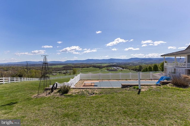 view of yard with fence, a patio area, and a mountain view