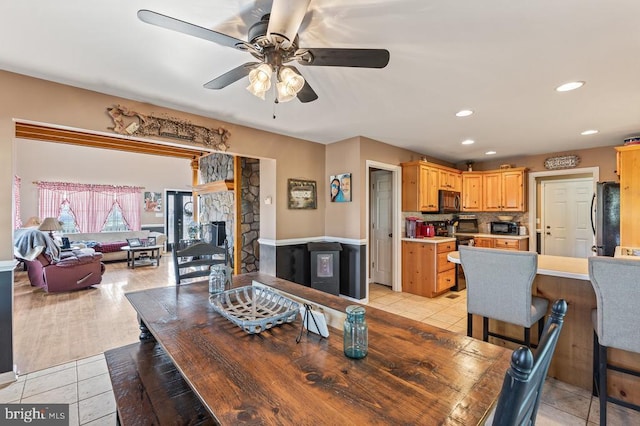 dining area with ceiling fan, recessed lighting, a fireplace, and light tile patterned floors