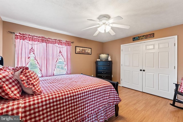 bedroom with a ceiling fan, light wood-style floors, and a closet