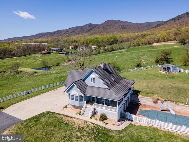 birds eye view of property with a water and mountain view