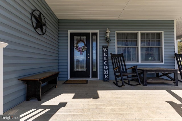 view of exterior entry with a porch