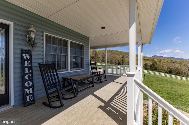 view of patio featuring covered porch and a mountain view