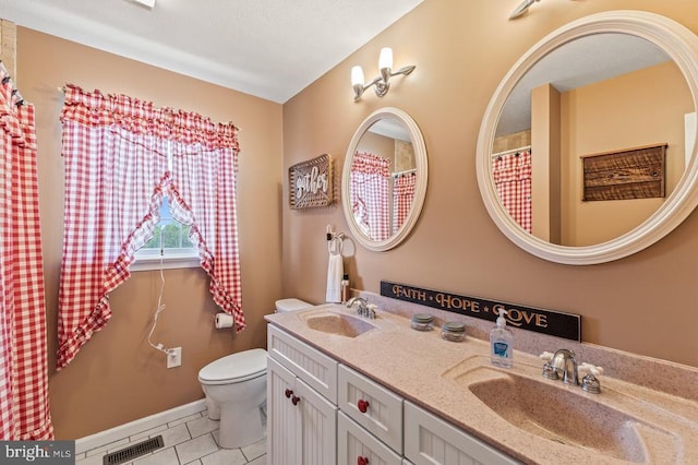full bath featuring toilet, tile patterned flooring, a sink, and visible vents