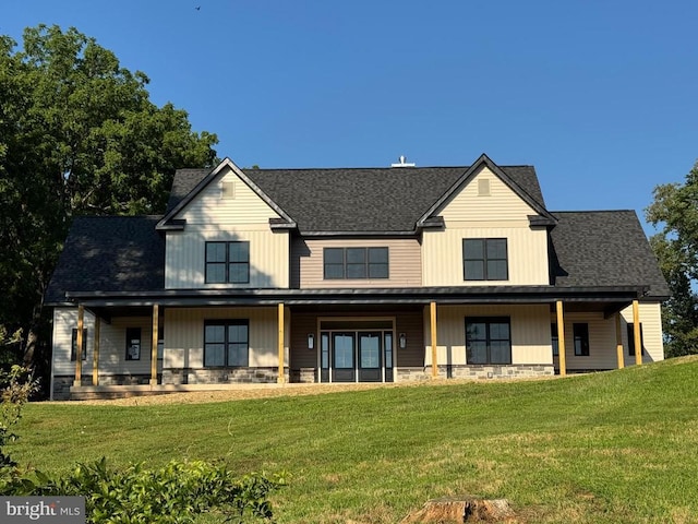  - modern inspired farmhouse featuring a porch, a front lawn, roof with shingles, and stone siding