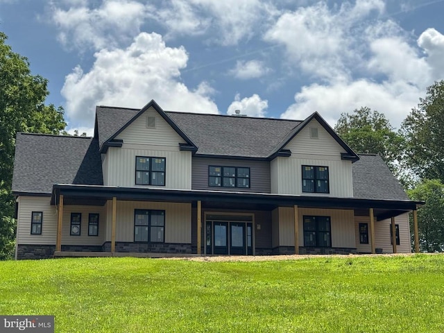  - modern inspired farmhouse with covered porch, roof with shingles, and a front lawn