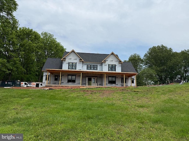  - view of front facade featuring a front lawn and a porch