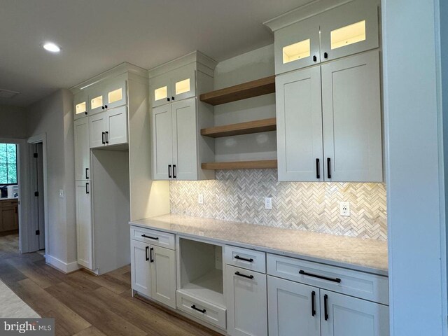  - kitchen with open shelves, wood finished floors, backsplash, white cabinets, and recessed lighting