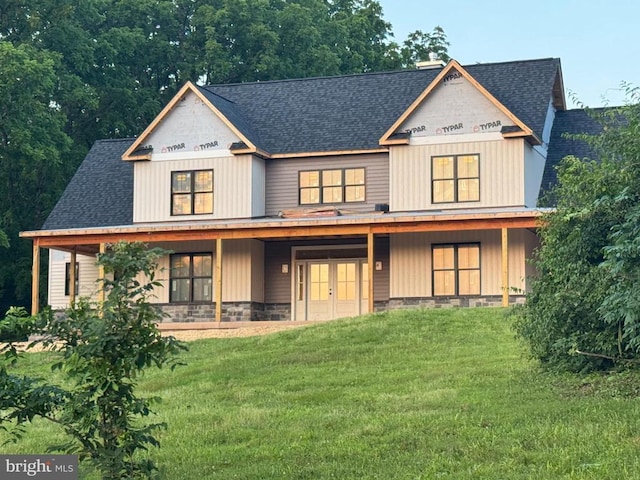  - view of front of home with roof with shingles, a front lawn, french doors, and covered porch