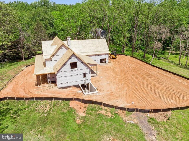  - aerial view of property and surrounding area featuring a heavily wooded area