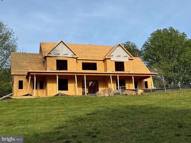  - rear view of house with a lawn