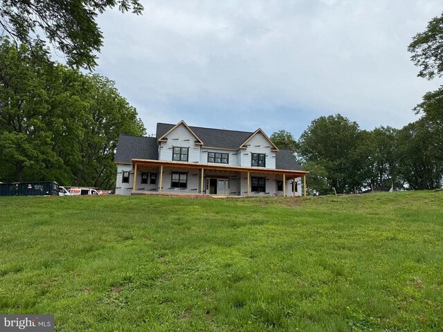  - rear view of house with a yard