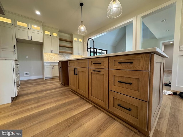  - kitchen with light wood-style floors, white cabinetry, backsplash, glass insert cabinets, and recessed lighting