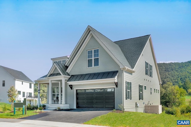 modern inspired farmhouse featuring driveway, a standing seam roof, brick siding, and an attached garage