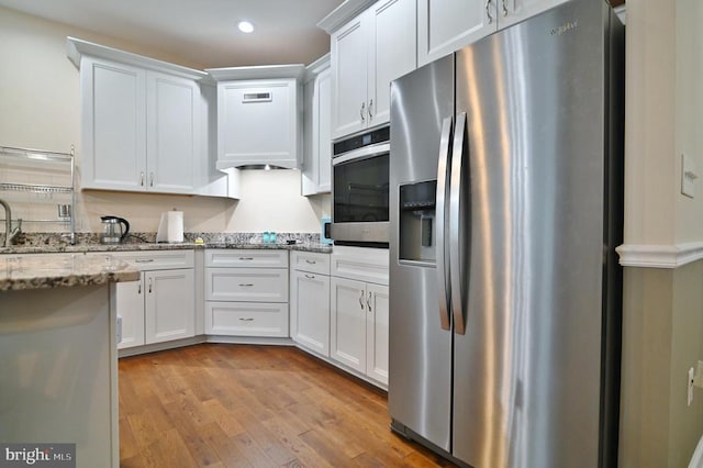 1835 Mill Creek Xrds, Luray, VA 22835 - kitchen featuring appliances with stainless steel finishes, white cabinetry, light wood-style floors, light stone counters, and recessed lighting