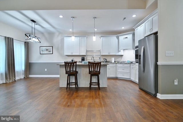 1835 Mill Creek Xrds, Luray, VA 22835 - kitchen with stainless steel appliances, a breakfast bar, a center island, white cabinetry, and dark wood-style floors