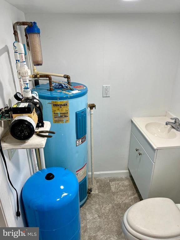 1184 Rocky Branch Rd, Luray, VA 22835 - bathroom featuring water heater, vanity, baseboards, and toilet