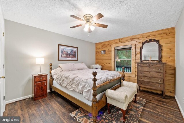 468 George James Loop, Radiant, VA 22732 - bedroom with baseboards, dark wood finished floors, wood walls, and a textured ceiling