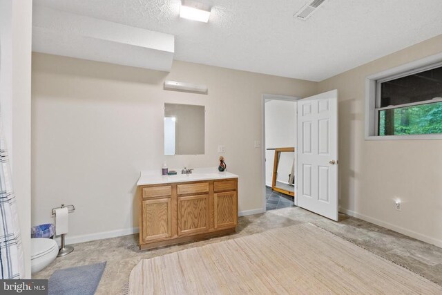468 George James Loop, Radiant, VA 22732 - bathroom featuring toilet, vanity, a textured ceiling, visible vents, and baseboards