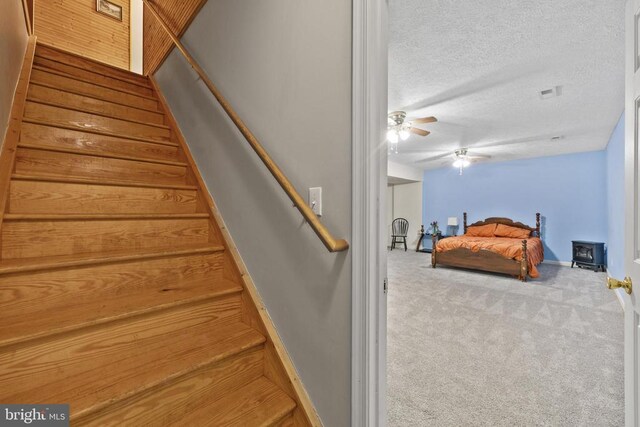 468 George James Loop, Radiant, VA 22732 - stairs featuring a textured ceiling, carpet, baseboards, visible vents, and ceiling fan