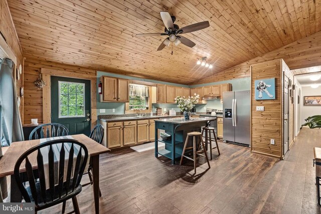 468 George James Loop, Radiant, VA 22732 - kitchen featuring ceiling fan, wooden walls, dark wood-style floors, a kitchen island, and appliances with stainless steel finishes