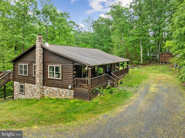468 George James Loop, Radiant, VA 22732 - view of front of home featuring covered porch, a chimney, a shed, log exterior, and gravel driveway