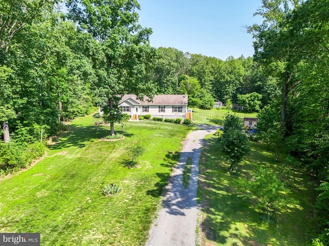  - aerial view of property and surrounding area with a heavily wooded area