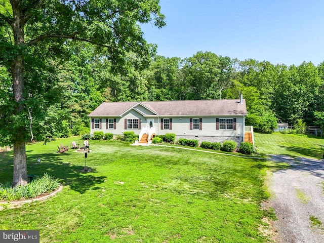  - view of front facade featuring a front yard and crawl space