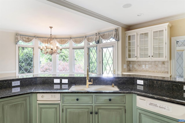 kitchen with dishwasher, a sink, green cabinetry, a chandelier, and ornamental molding