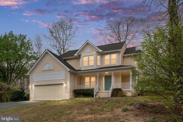 traditional-style house with covered porch and asphalt driveway