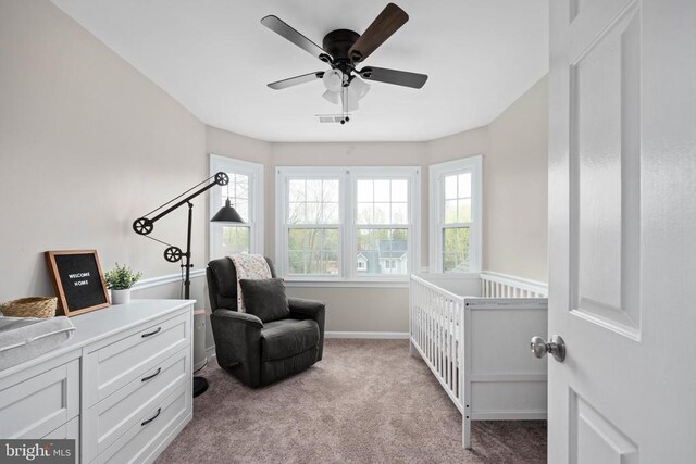 living area featuring carpet, healthy amount of natural light, ceiling fan, and baseboards