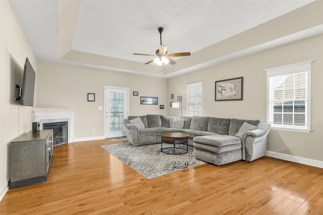 109 Beauregard Dr, Staunton, VA 24401 - living room featuring a tray ceiling, light wood-style floors, ceiling fan, and plenty of natural light