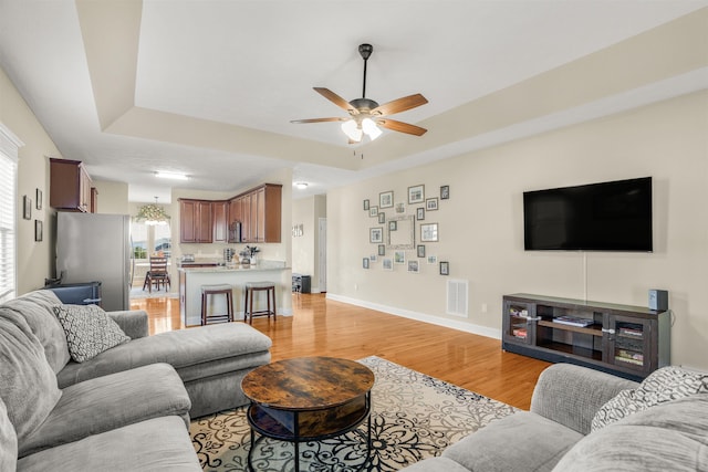 109 Beauregard Dr, Staunton, VA 24401 - living area featuring light wood-type flooring, a tray ceiling, and ceiling fan