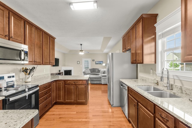 109 Beauregard Dr, Staunton, VA 24401 - kitchen featuring stainless steel appliances, open floor plan, light wood-type flooring, ceiling fan, and a fireplace