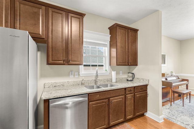 109 Beauregard Dr, Staunton, VA 24401 - kitchen featuring stainless steel dishwasher, freestanding refrigerator, light wood-type flooring, and light stone counters