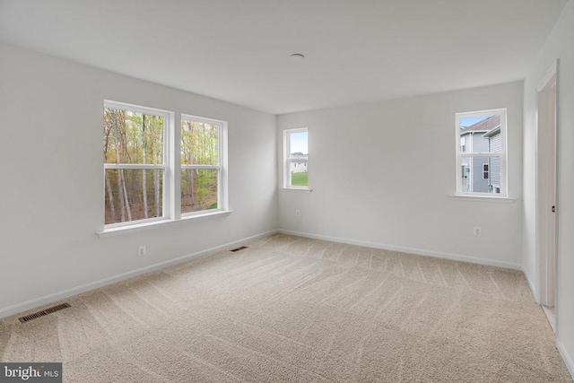unfurnished room featuring carpet flooring and baseboards