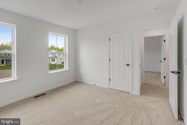 empty room featuring carpet flooring and baseboards