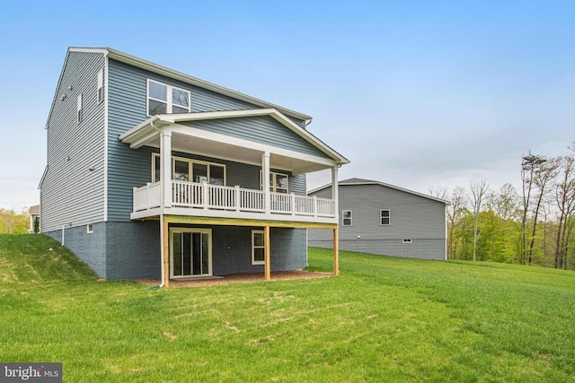 rear view of property featuring a yard and a wooden deck