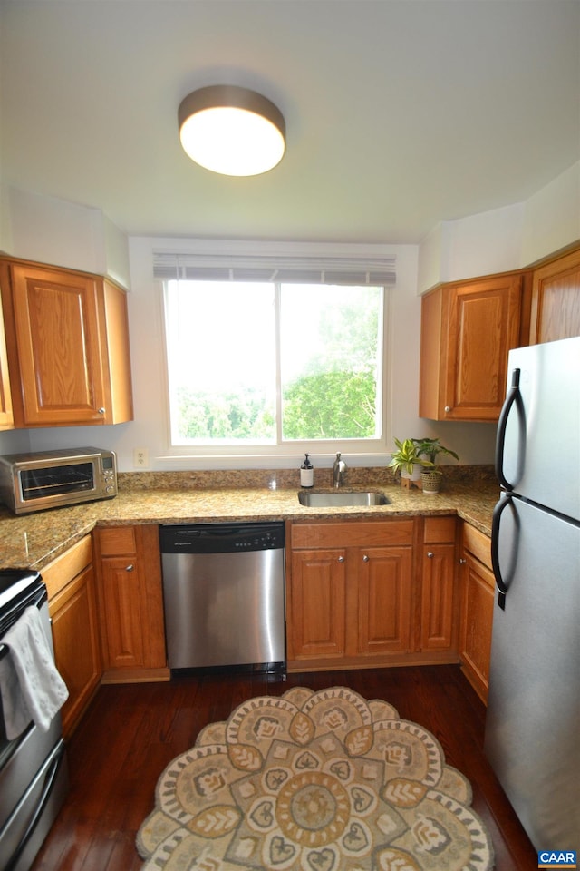 1606 Monticello Ave Unit G, Charlottesville, VA 22902 - kitchen featuring stainless steel appliances, dark wood-type flooring, brown cabinets, and light stone countertops