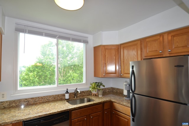 1606 Monticello Ave Unit G, Charlottesville, VA 22902 - kitchen with freestanding refrigerator, dishwasher, brown cabinets, and plenty of natural light