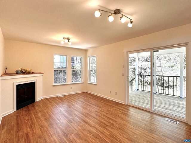 276 Rustling Oaks Way, Ruckersville, VA 22968 - unfurnished living room with plenty of natural light, wood finished floors, a fireplace, and baseboards