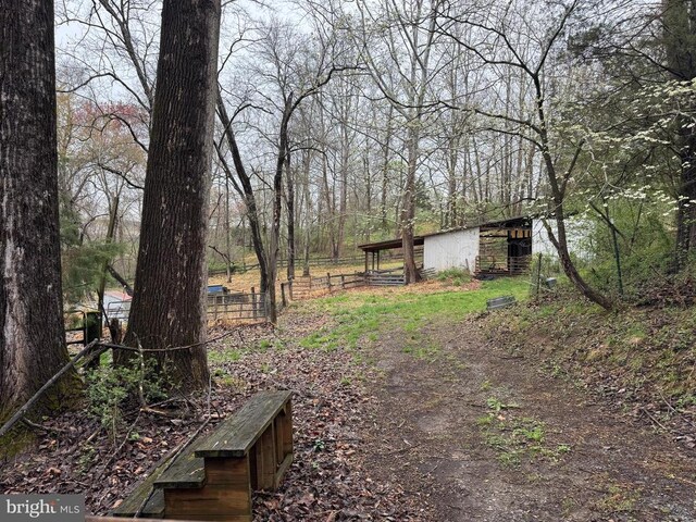 20 Victory Ln, Castleton, VA 22716 - view of yard with fence, a forest view, an outdoor structure, and an outbuilding