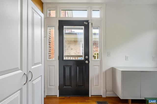 foyer featuring wood finished floors
