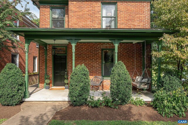 entrance to property featuring brick siding