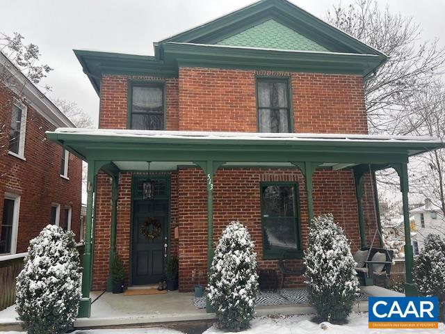 view of front of property with a porch and brick siding