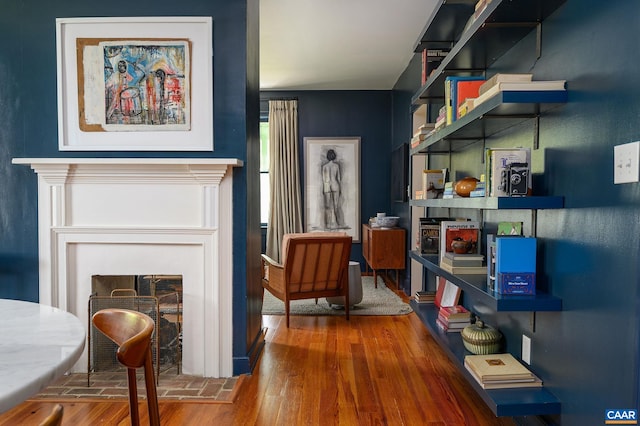 living area with a fireplace and wood finished floors