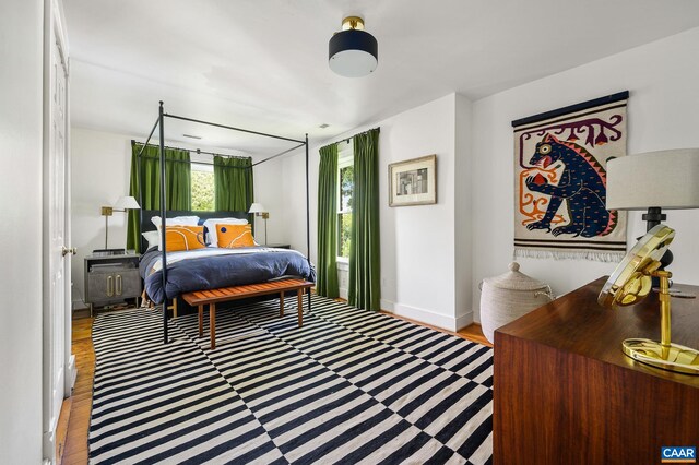 bedroom featuring baseboards and wood finished floors