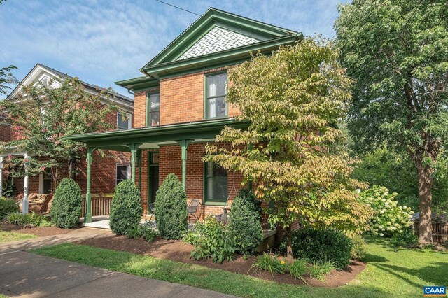view of front of home featuring a porch and brick siding