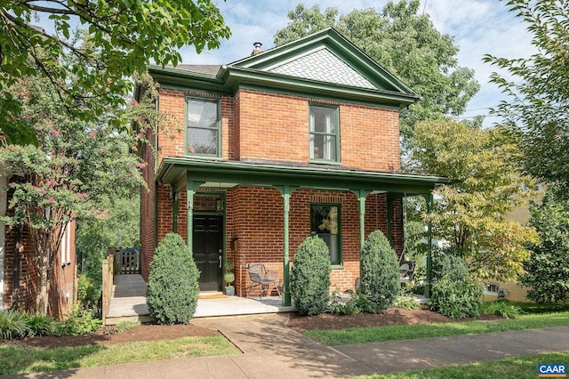 view of front of property featuring covered porch and brick siding